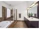 Bright bathroom featuring a double sink vanity, tile flooring, and a glass-enclosed shower at 976 Arthur Nw Ln, Atlanta, GA 30318