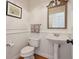 Charming powder room with pedestal sink, mirror and patterned hand towels at 976 Arthur Nw Ln, Atlanta, GA 30318