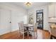 Charming dining area with hardwood floors, shiplap accent wall, and table with chairs at 976 Arthur Nw Ln, Atlanta, GA 30318