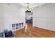 Dining room featuring hardwood floors, paneled walls, and seamless connection to a modern kitchen at 976 Arthur Nw Ln, Atlanta, GA 30318