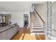 Bright foyer with hardwood floors, staircase, and natural light creates an inviting entryway to the home at 976 Arthur Nw Ln, Atlanta, GA 30318