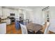 Spacious kitchen with white cabinets, stainless steel appliances, hardwood floors, and kitchen table with chairs at 976 Arthur Nw Ln, Atlanta, GA 30318