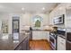 Bright kitchen features granite counters, stainless steel appliances, and a dark island with seating at 976 Arthur Nw Ln, Atlanta, GA 30318