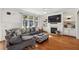 Comfortable living room with hardwood floors, fireplace, and large windows, perfect for relaxation and Gathering time at 976 Arthur Nw Ln, Atlanta, GA 30318