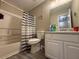 Modest bathroom with a tub and shower, sink, and vinyl plank flooring at 229 Odyssey Turn, Conyers, GA 30012