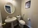 Small half bathroom featuring a pedestal sink, toilet, and framed art on the wall at 229 Odyssey Turn, Conyers, GA 30012