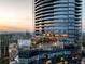 Stunning aerial view of a modern high-rise building at sunset with city skyline in the background at 3344 Peachtree Ne Rd # 3005, Atlanta, GA 30326