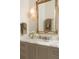 Bathroom vanity featuring a marble countertop and traditional mirror at 3344 Peachtree Ne Rd # 3005, Atlanta, GA 30326