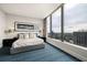 Serene bedroom with a king-size bed, cityscape views through large windows, and stylish décor at 3344 Peachtree Ne Rd # 3005, Atlanta, GA 30326