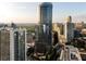 Modern high-rise building with glass facade, surrounding buildings, and landscaped grounds at 3344 Peachtree Ne Rd # 3005, Atlanta, GA 30326