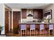 Modern kitchen features sleek wood cabinets, tile backsplash, and breakfast bar with seating for four at 3344 Peachtree Ne Rd # 3005, Atlanta, GA 30326
