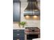 Modern kitchen featuring custom cabinetry, stainless steel appliances, and a stylish range hood at 3344 Peachtree Ne Rd # 3005, Atlanta, GA 30326