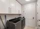 Functional laundry room with modern washer and dryer and ample cabinet storage at 3344 Peachtree Ne Rd # 3005, Atlanta, GA 30326