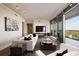 Elegant living room with modern furnishings, a large TV, and floor-to-ceiling windows with panoramic views at 3344 Peachtree Ne Rd # 3005, Atlanta, GA 30326