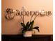 Buckhead Club sign, orchid, and decor on a polished dark wooden table adds elegance to the inviting entrance space at 3344 Peachtree Ne Rd # 3005, Atlanta, GA 30326