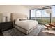Serene main bedroom with a tufted headboard, floor-to-ceiling windows, and a comfortable seating area at 3344 Peachtree Ne Rd # 3005, Atlanta, GA 30326