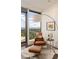 Comfortable seating area with large windows offering city views in this sophisticated main bedroom at 3344 Peachtree Ne Rd # 3005, Atlanta, GA 30326