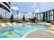 Rooftop pool offers a luxurious retreat with modern lounge chairs, lush landscaping, and city views on a sunny day at 3344 Peachtree Ne Rd # 3005, Atlanta, GA 30326