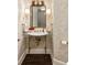 Charming powder room featuring a decorative mirror, stylish sconces, and patterned wallpaper at 3344 Peachtree Ne Rd # 3005, Atlanta, GA 30326