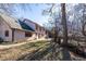 Expansive backyard featuring a large yard with mature trees, patio area, and wooden deck at 5479 Dorsett Shoals Rd, Douglasville, GA 30135