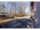 Backyard area showcasing a spacious patio, swing set, wooden deck, and lush trees at 5479 Dorsett Shoals Rd, Douglasville, GA 30135