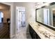 Bathroom featuring a vanity with marble countertop, a large mirror and a shower/tub with a patterned shower curtain at 5479 Dorsett Shoals Rd, Douglasville, GA 30135