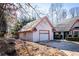 Charming home exterior with attached garage, pink trim, and a well-maintained yard on a sunny day at 5479 Dorsett Shoals Rd, Douglasville, GA 30135