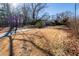 A large front yard with dormant grass and mature trees on a sunny day at 5479 Dorsett Shoals Rd, Douglasville, GA 30135