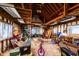 Messy garage interior featuring exposed wood framing and filled with various stored items at 5479 Dorsett Shoals Rd, Douglasville, GA 30135