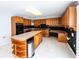 Kitchen boasts plentiful wood cabinetry, contrasting black backsplash and black appliances, plus a center island at 5479 Dorsett Shoals Rd, Douglasville, GA 30135