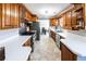 Kitchen boasts white countertops, stainless steel appliances, and ample wooden cabinet storage at 5479 Dorsett Shoals Rd, Douglasville, GA 30135