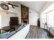 Bright living room featuring a stone fireplace, vaulted ceiling, and large windows with natural light at 5479 Dorsett Shoals Rd, Douglasville, GA 30135