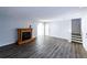 Open-concept living room with gray walls, wood floors, fireplace, and stairway to the second level at 5479 Dorsett Shoals Rd, Douglasville, GA 30135