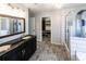 Well-lit main bathroom featuring a double sink vanity, shower, and neutral decor at 5479 Dorsett Shoals Rd, Douglasville, GA 30135
