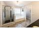 Clean main bathroom featuring a separate shower, soaking tub, and modern finishes at 5479 Dorsett Shoals Rd, Douglasville, GA 30135