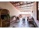 Charming covered patio featuring wicker seating, tiled floor and a corrugated metal roof at 5479 Dorsett Shoals Rd, Douglasville, GA 30135