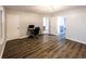 Light-filled room features wood floors, neutral walls, doors, and an alcove with a desk setup at 5479 Dorsett Shoals Rd, Douglasville, GA 30135