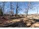 Spacious front yard with trees, showcasing the property's natural surroundings at 5479 Dorsett Shoals Rd, Douglasville, GA 30135