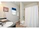 Bright bathroom showcases double sinks and a shower with a white shower curtain at 692 Oakside Pl, Acworth, GA 30102