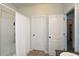 Bright bathroom features a shower with a white curtain and white doors to adjoining rooms at 692 Oakside Pl, Acworth, GA 30102