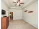 Bedroom featuring a ceiling fan, a dresser, a TV, and wooden wall shelves at 692 Oakside Pl, Acworth, GA 30102