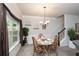 Inviting dining room featuring classic decor, comfortable seating, and natural light from the window at 692 Oakside Pl, Acworth, GA 30102