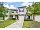 Inviting townhome showcasing a stone accent, colorful shutters, and a lush green lawn at 692 Oakside Pl, Acworth, GA 30102