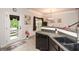 Well-appointed kitchen with stone countertop, sleek appliances, and convenient access to the outdoor patio at 692 Oakside Pl, Acworth, GA 30102