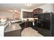 Contemporary kitchen featuring sleek black appliances, granite countertops, and ample cabinet space at 692 Oakside Pl, Acworth, GA 30102