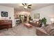 Inviting living room featuring a ceiling fan, plush seating, and an open floor plan at 692 Oakside Pl, Acworth, GA 30102