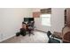 Well-lit office with a window view, desk, monitors, and neutral walls at 692 Oakside Pl, Acworth, GA 30102