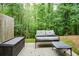 Relaxing outdoor patio featuring comfortable seating amidst a serene, wooded backdrop at 692 Oakside Pl, Acworth, GA 30102