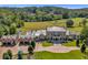 Expansive estate showcasing the home, a pool, manicured lawn, and paddock surrounded by lush greenery at 1040 W Conway Nw Dr, Atlanta, GA 30327