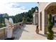 Expansive balcony features stone flooring, elegant columns, decorative potted plants, and beautiful views of the estate at 1040 W Conway Nw Dr, Atlanta, GA 30327